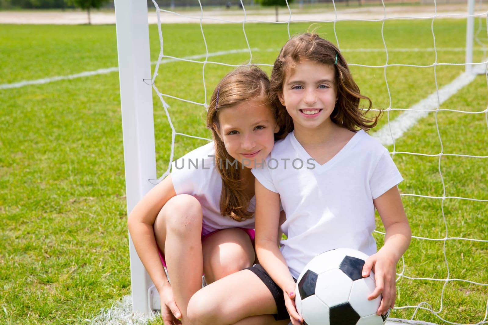 Soccer football kid girls playing on sports outdoor field