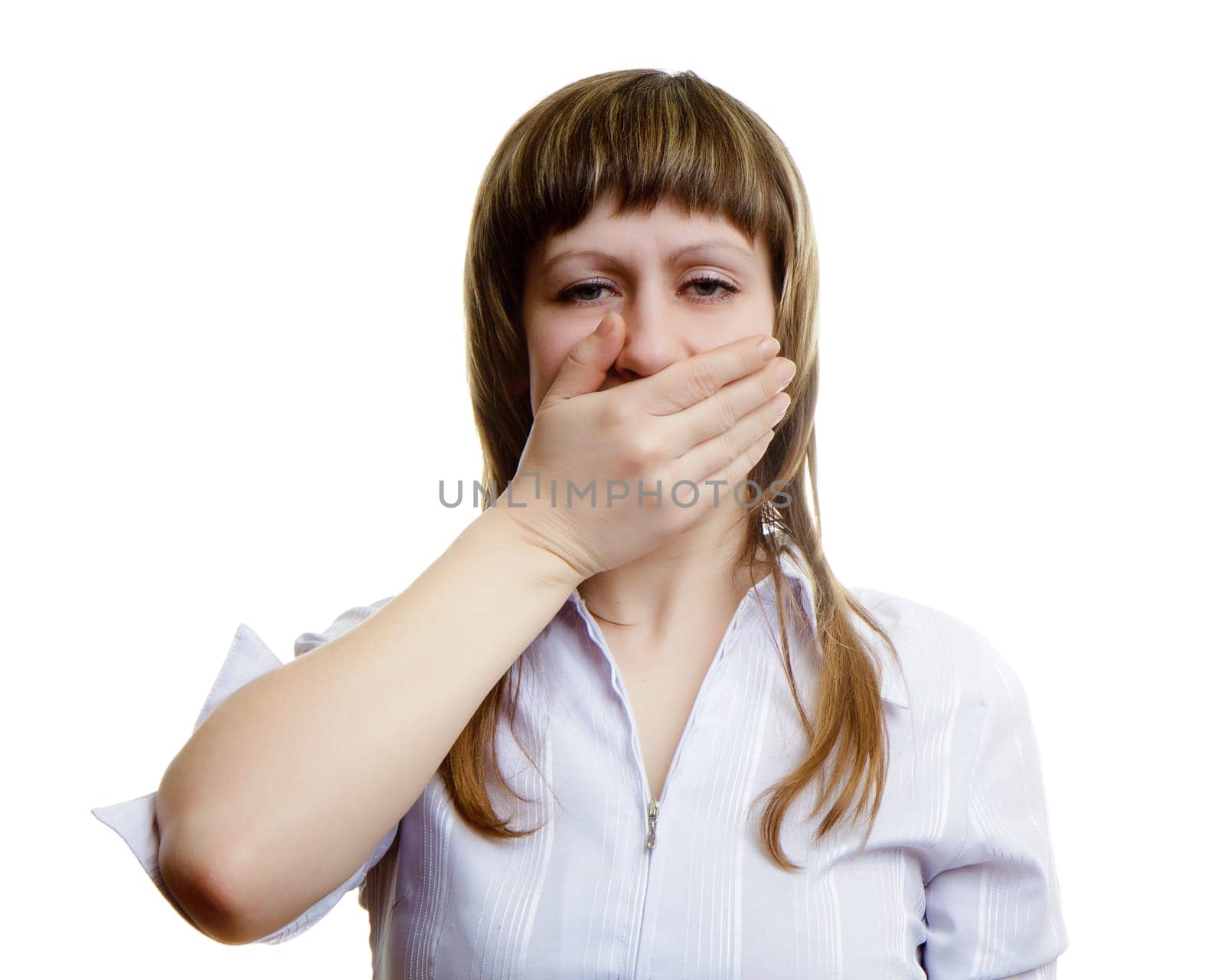 young girl covers her mouth with his hands on a white background