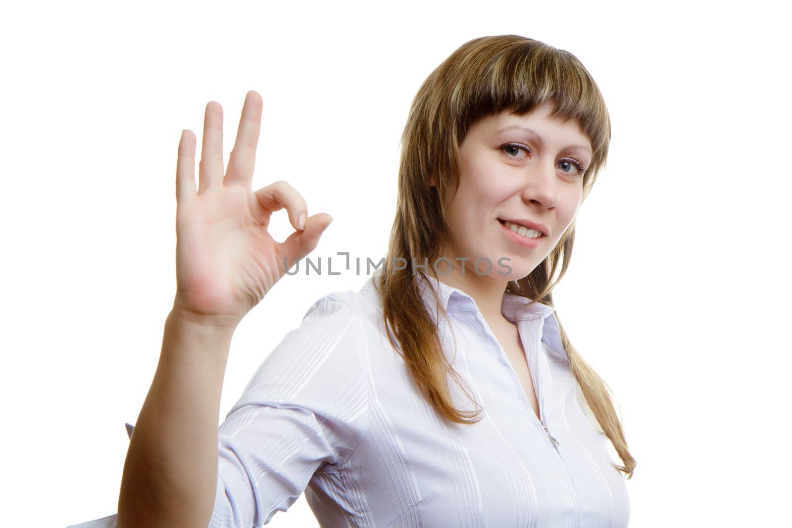 Young girl shows sign ok on a white background