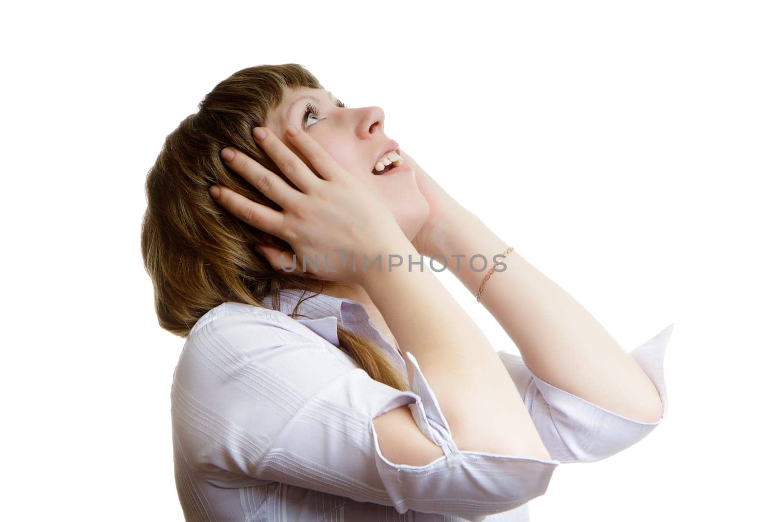 young girl looks up in horror on a white background