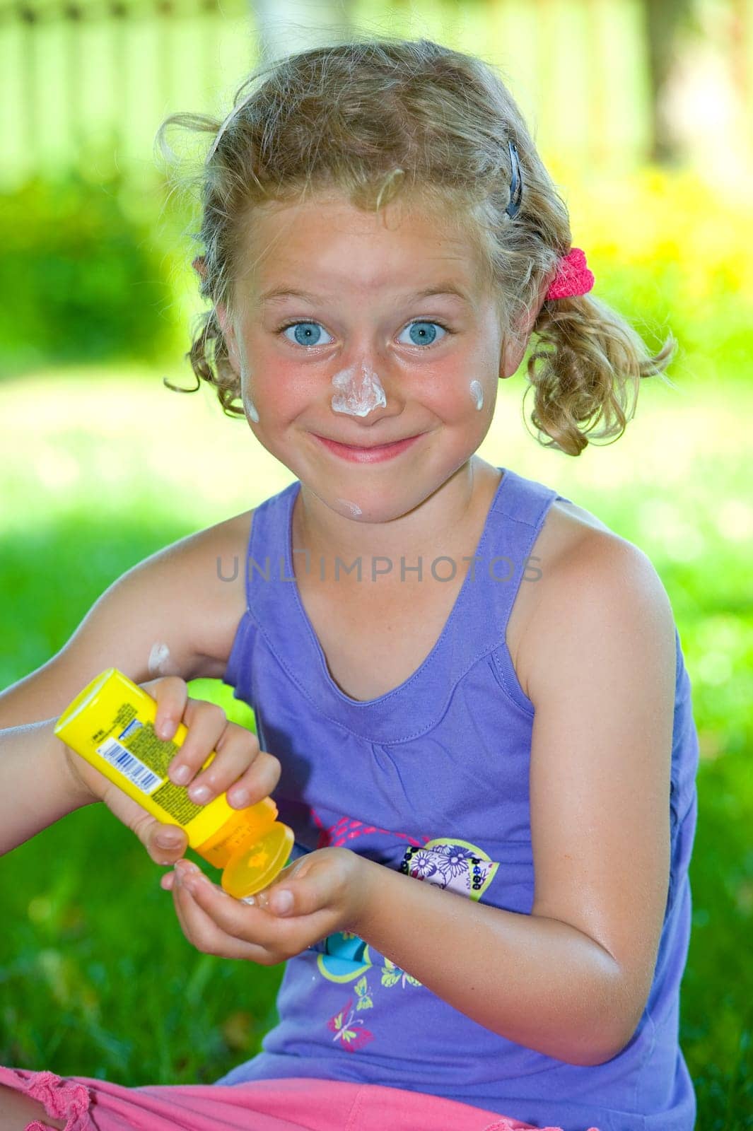 funny girl with suncream