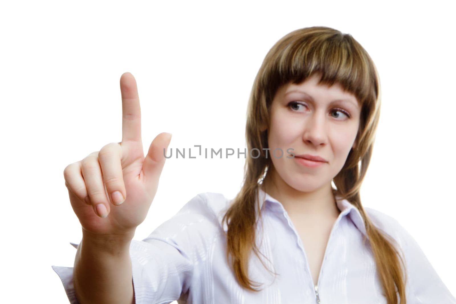young girl pushes imaginary button on a white background