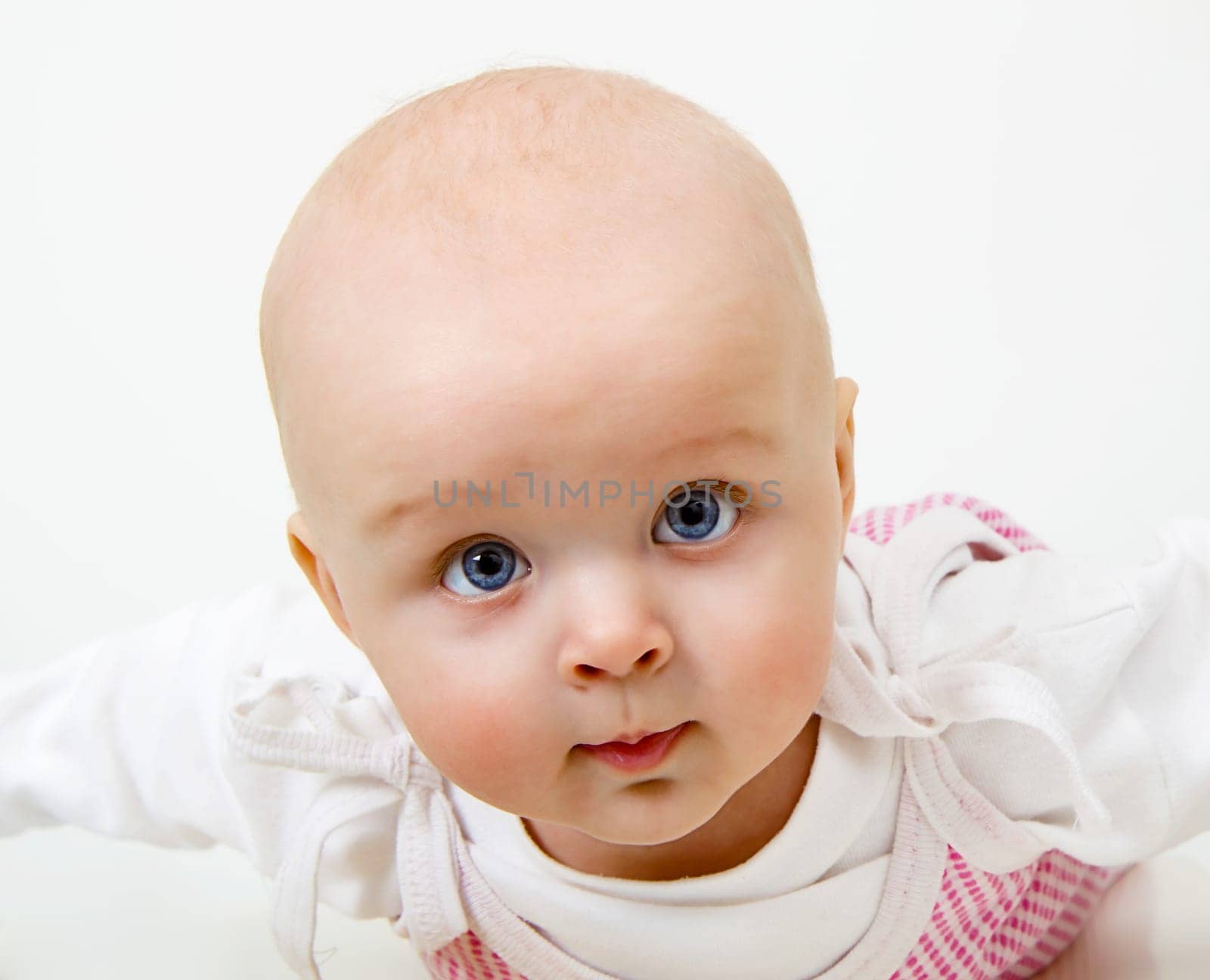 portrait of a blue-eyed baby girl on a light background