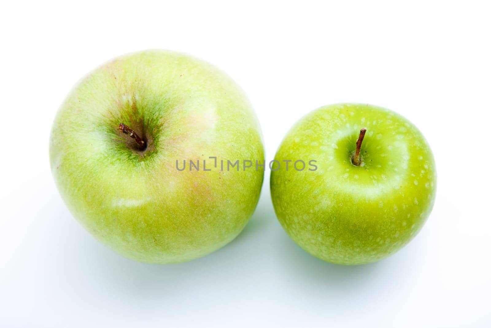 Two green apples on a light background