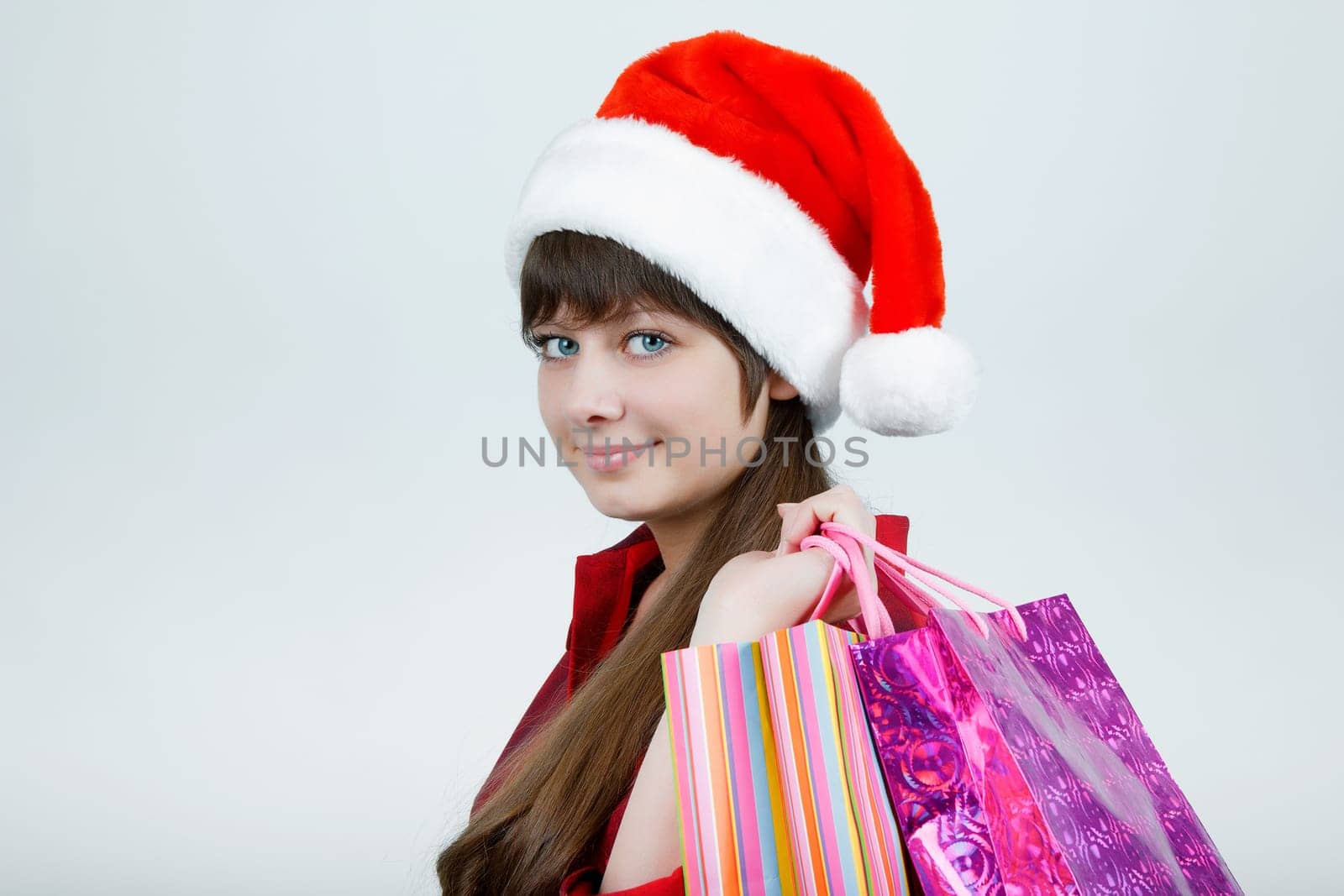 A girl in a Christmas hat with shopping