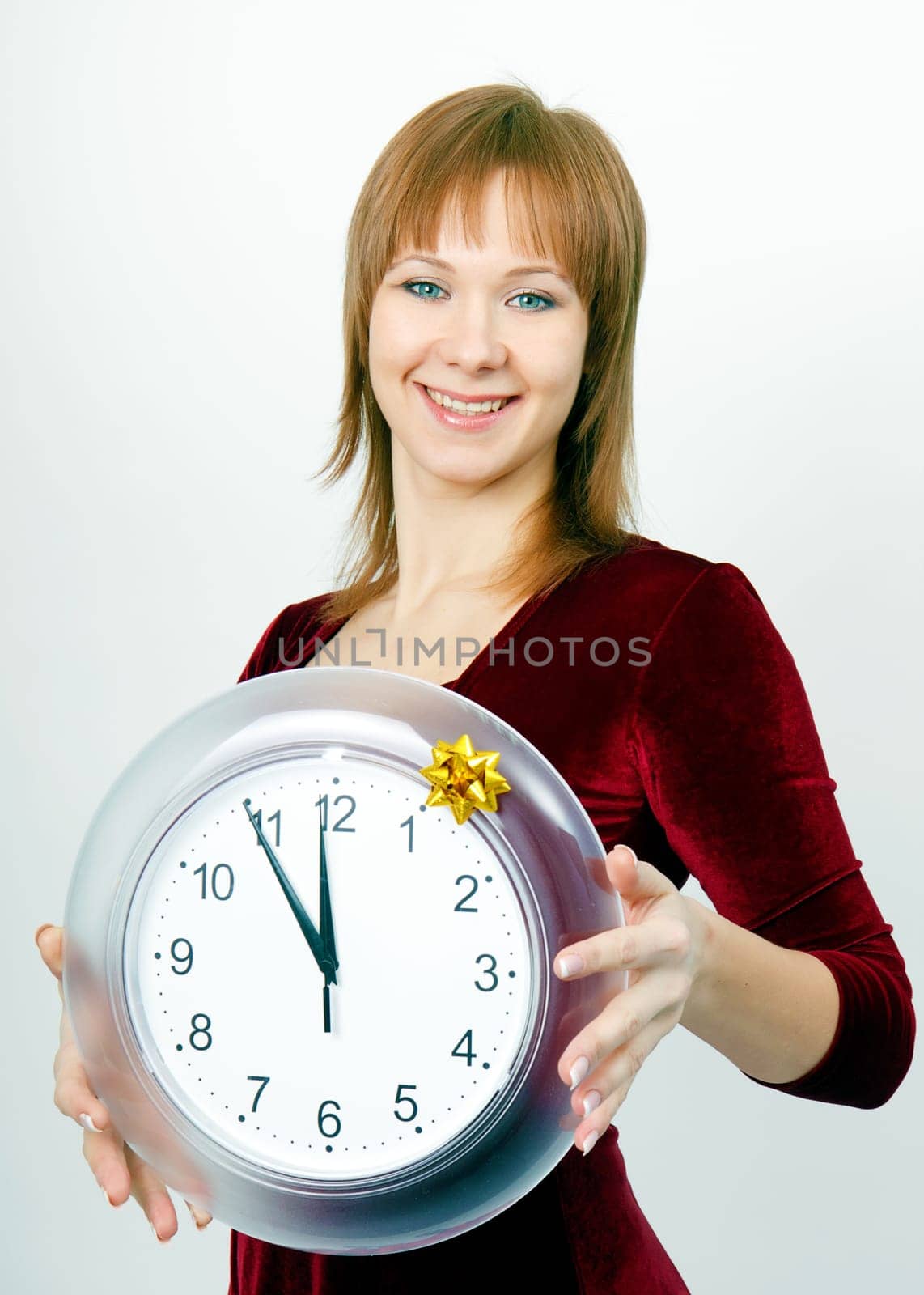 attractive girl with a clock on the eve of Christmas