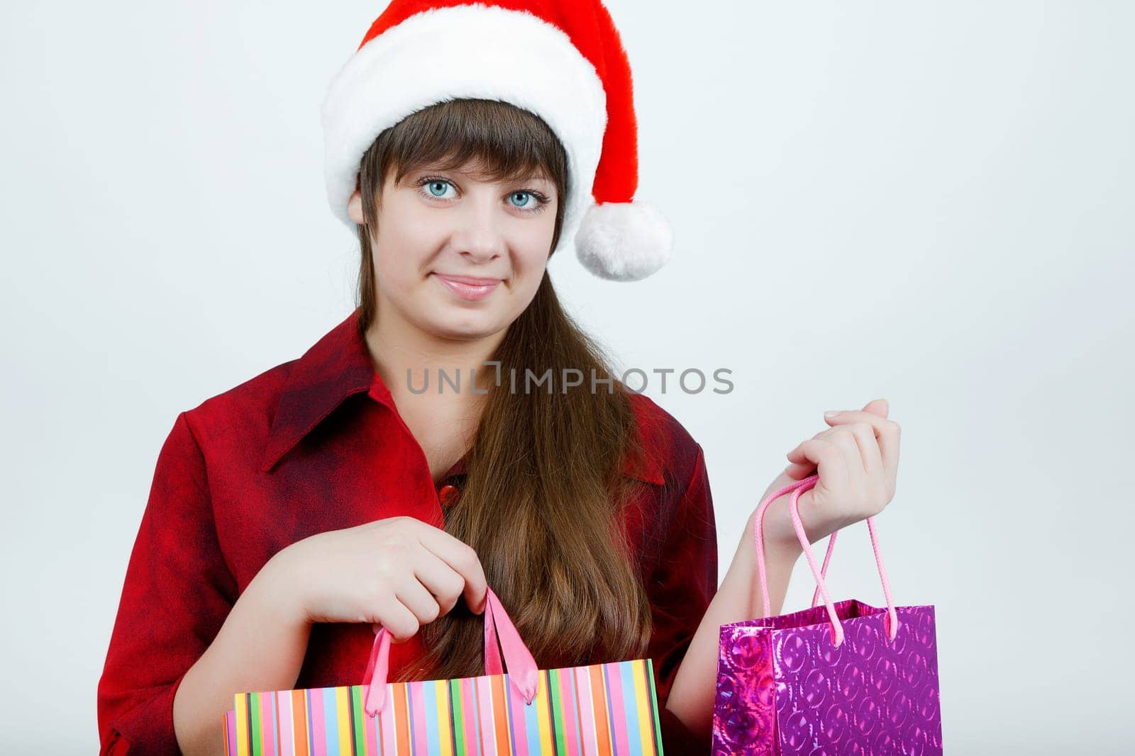 A girl in a Christmas hat with shopping