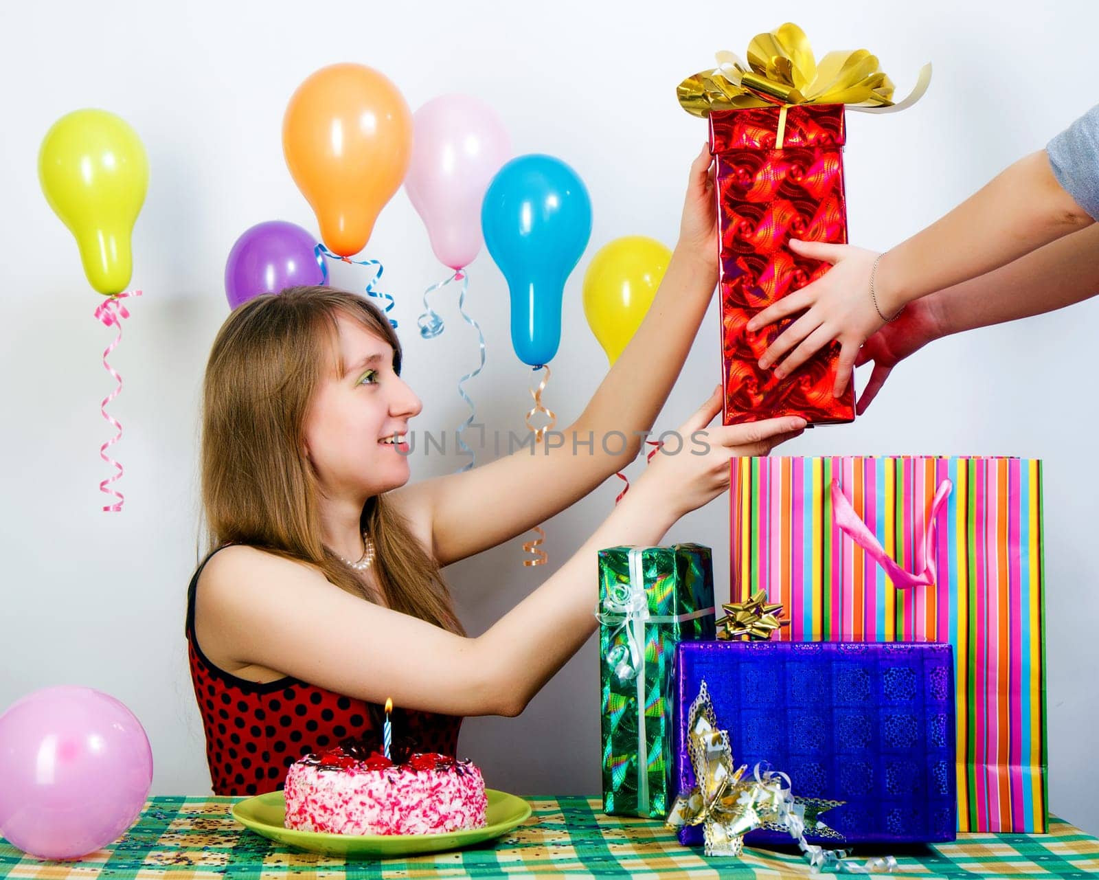 Birthday. The girl happily accepts gifts from friends