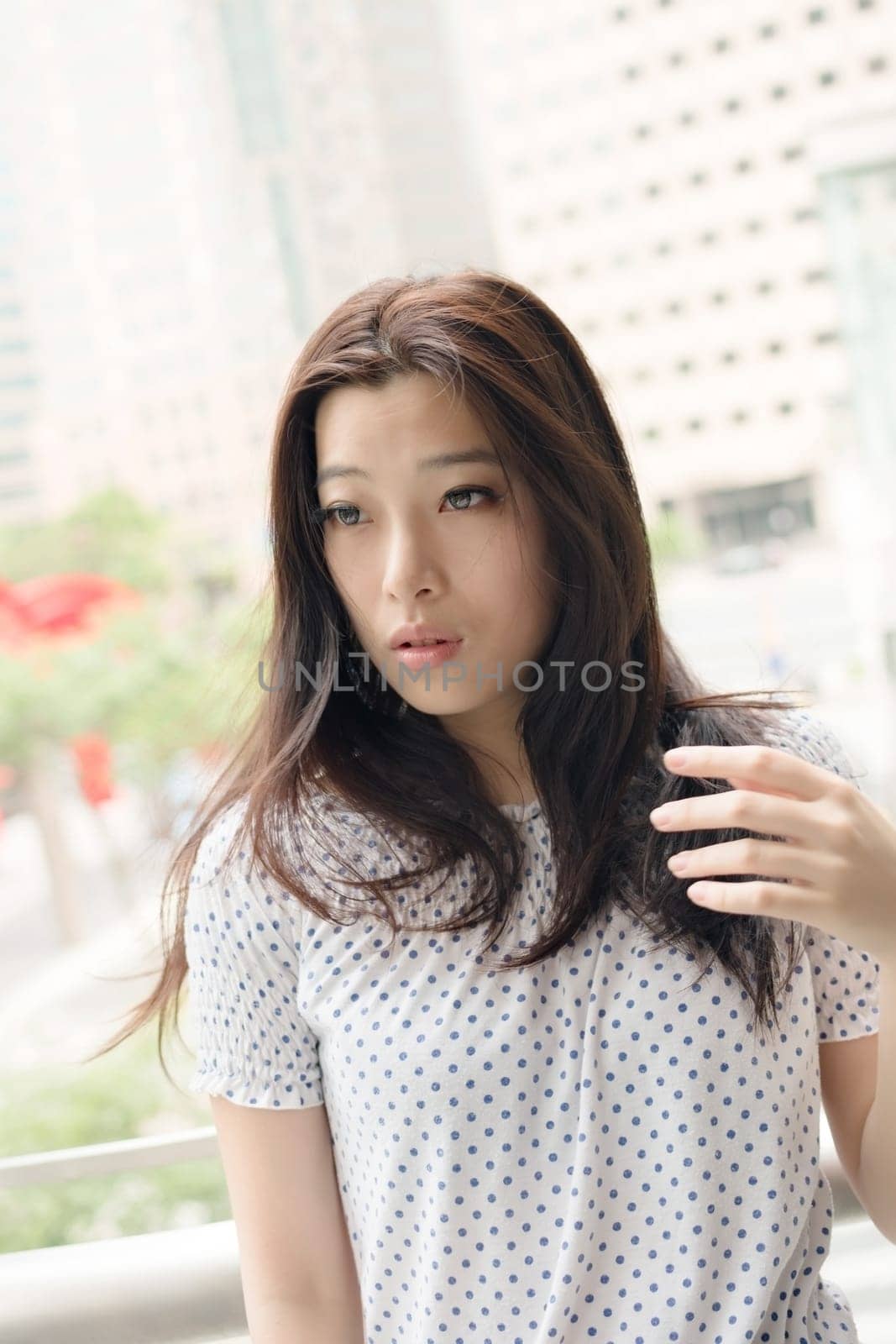 Attractive young woman, closeup glamour portrait at street in modern city, Taipei, Taiwan, Asia.