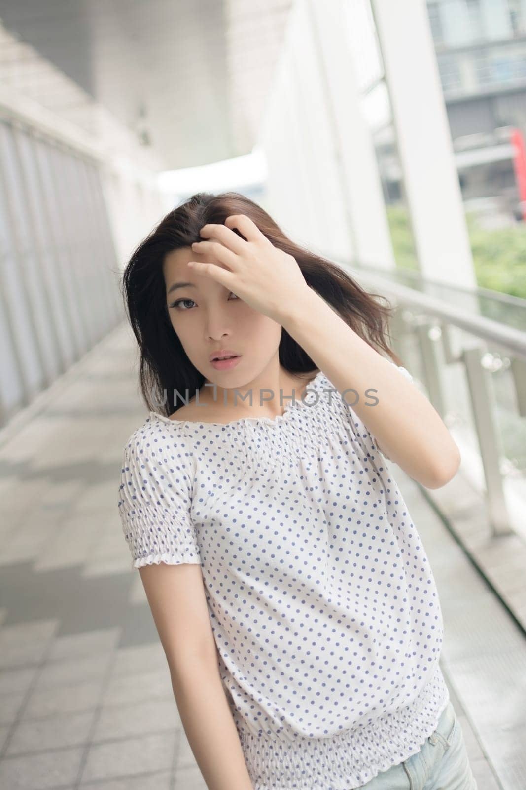 Attractive young woman, closeup glamour portrait at street in modern city, Taipei, Taiwan, Asia.