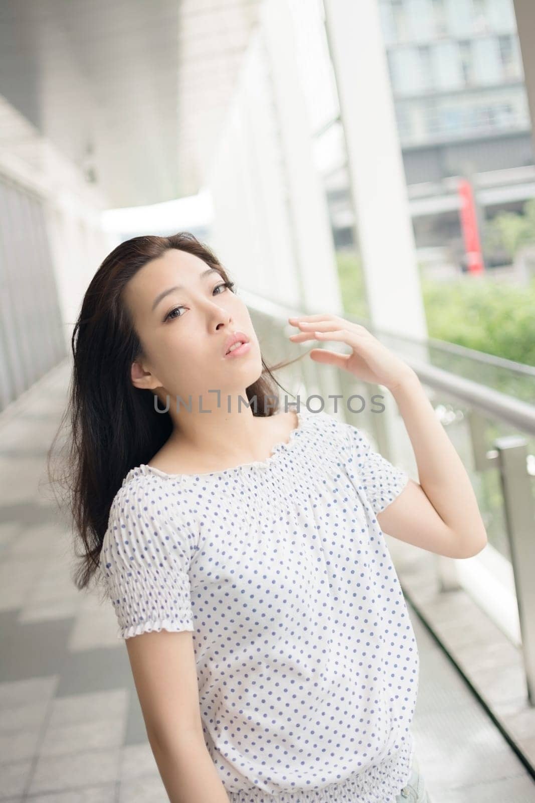 Attractive young woman, closeup glamour portrait at street in modern city, Taipei, Taiwan, Asia.