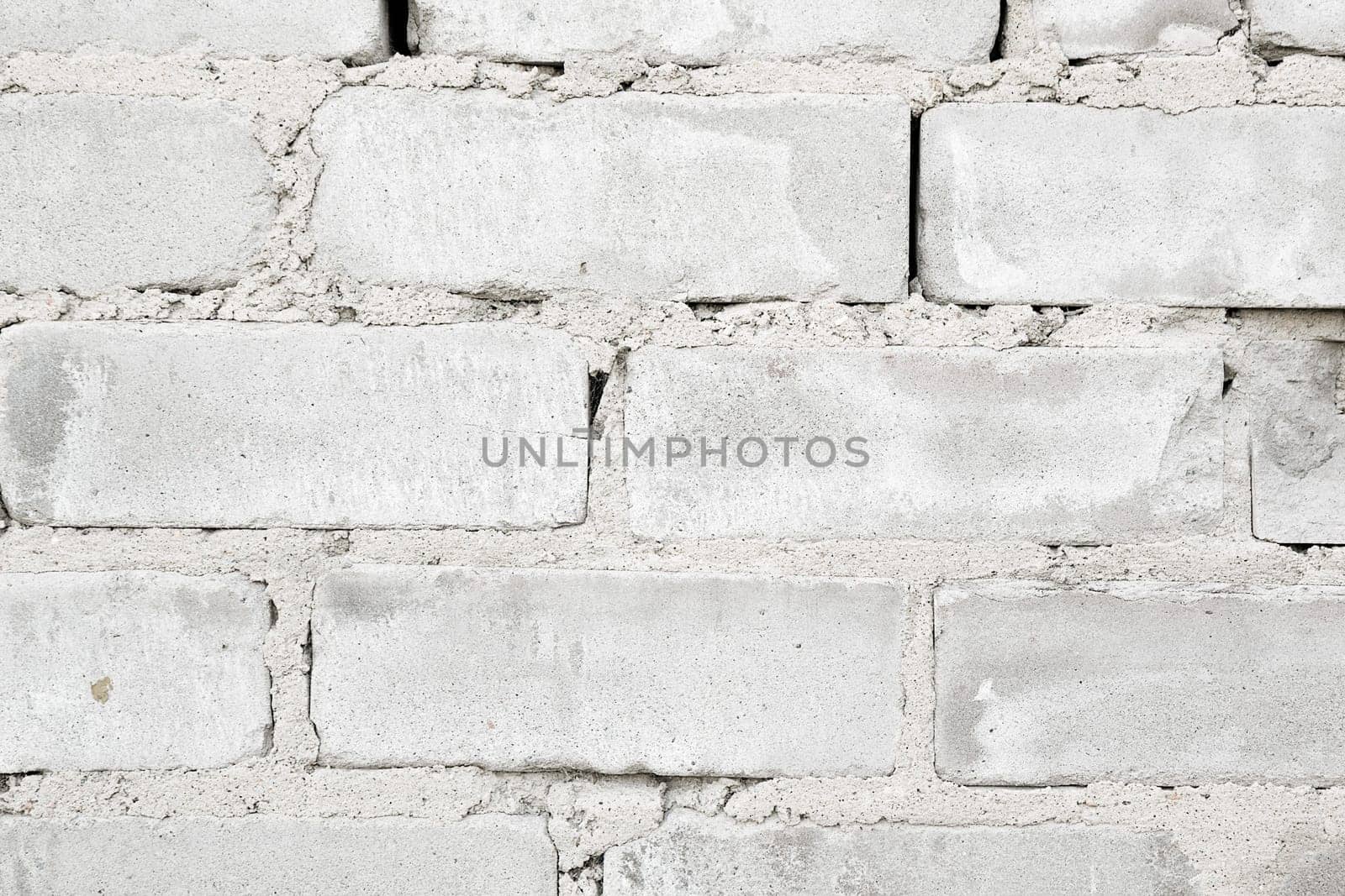 rough rough wall of gray brick with cement