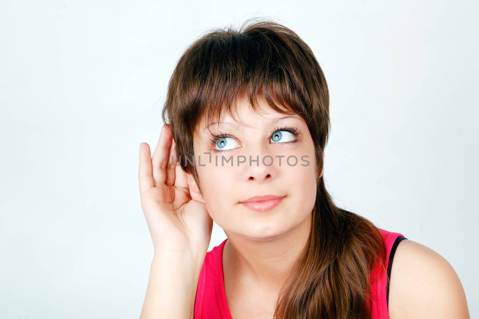attractive girl listening put his hand to his ear