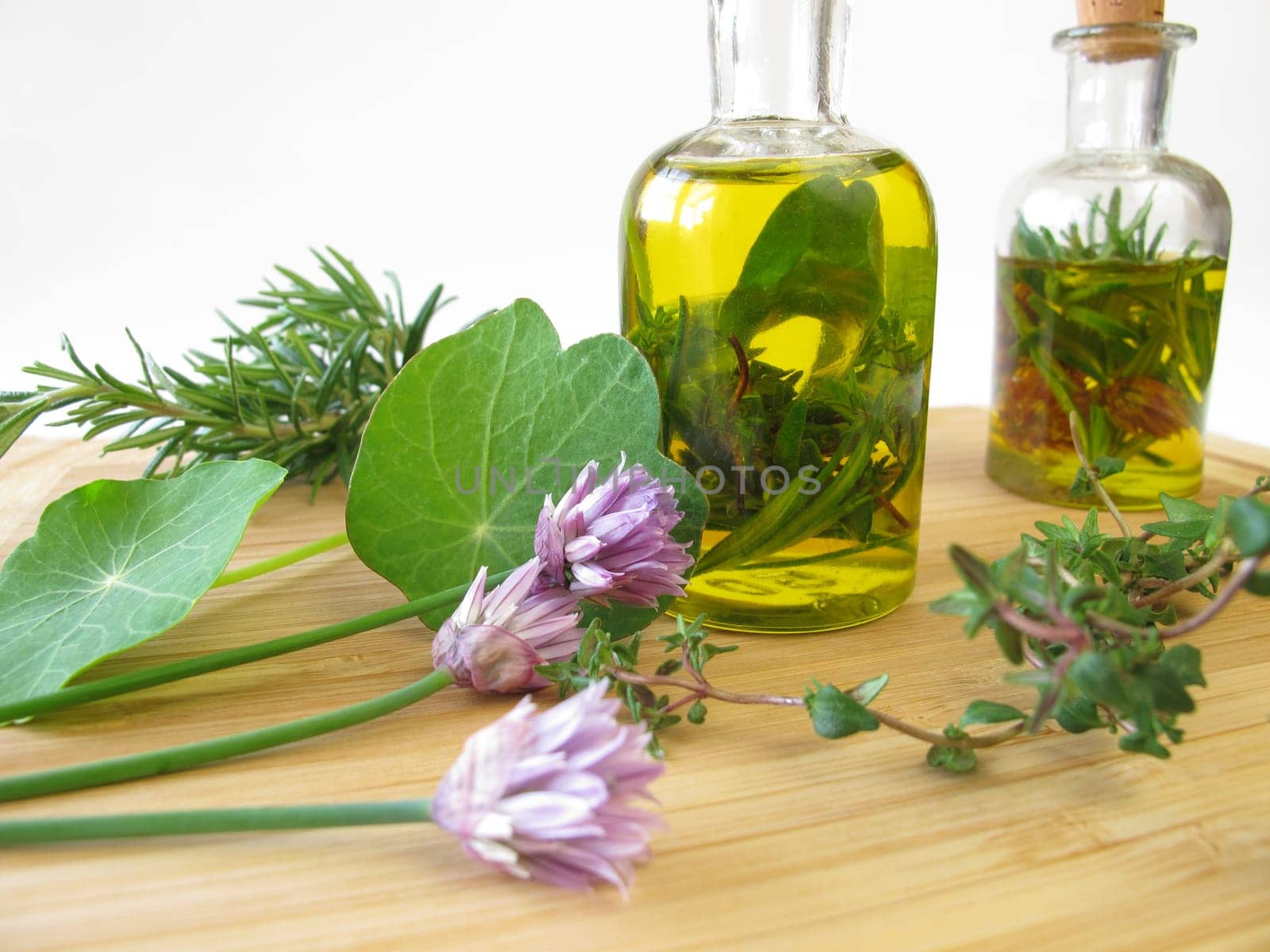 Homemade herbal oil with chive flowers