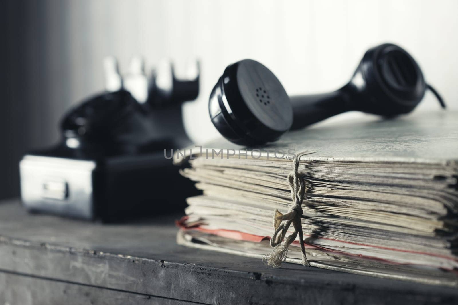 A desk with documents, Old phone on the background