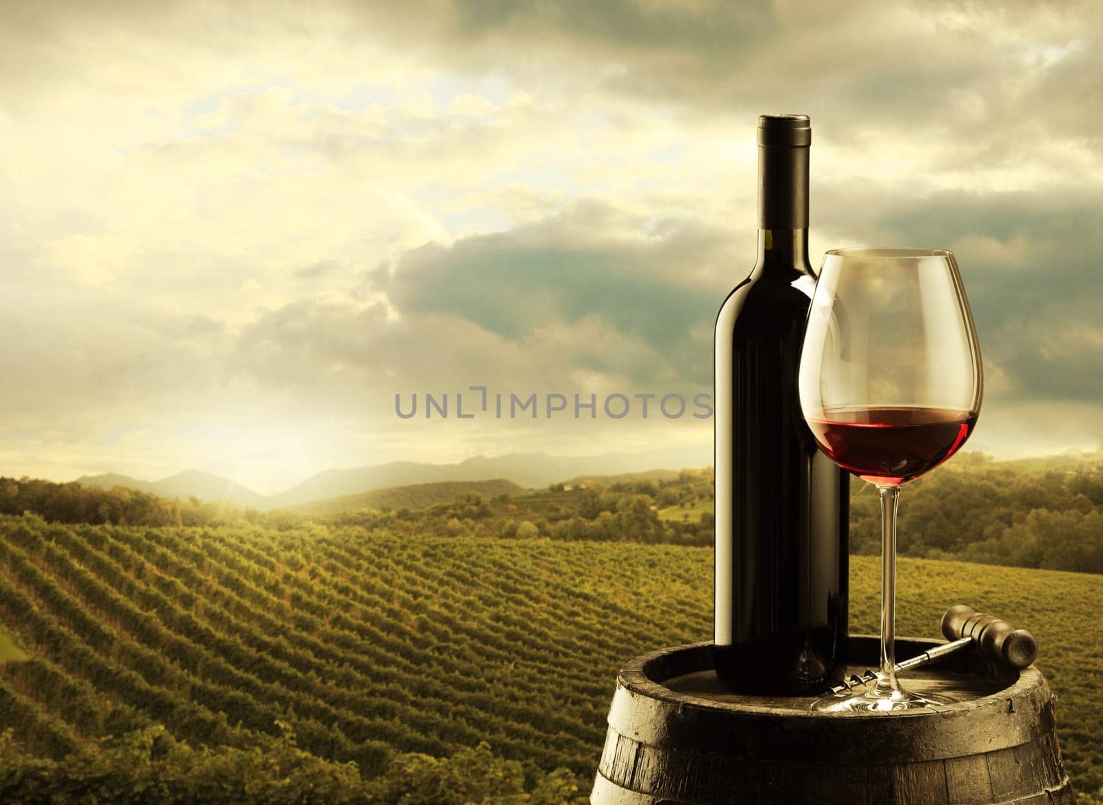 red wine bottle and wine glass on wodden barrel