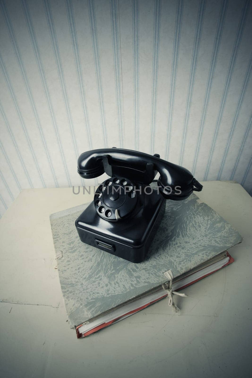 Old phone on a stack of documents