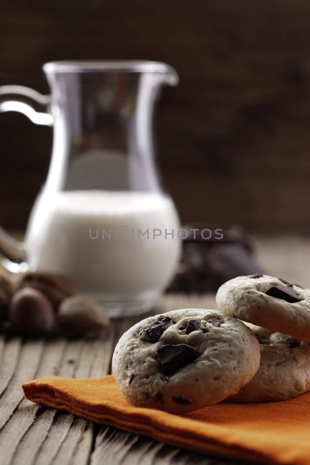 Chocolate chip cookies with ingredients in the background