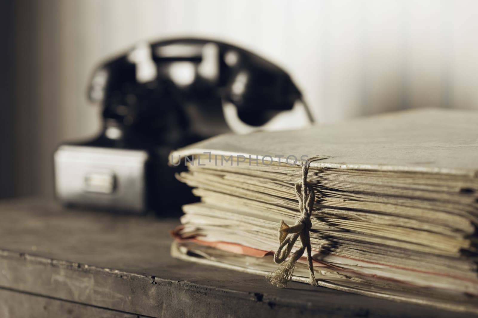 A desk with documents, Old phone on the background