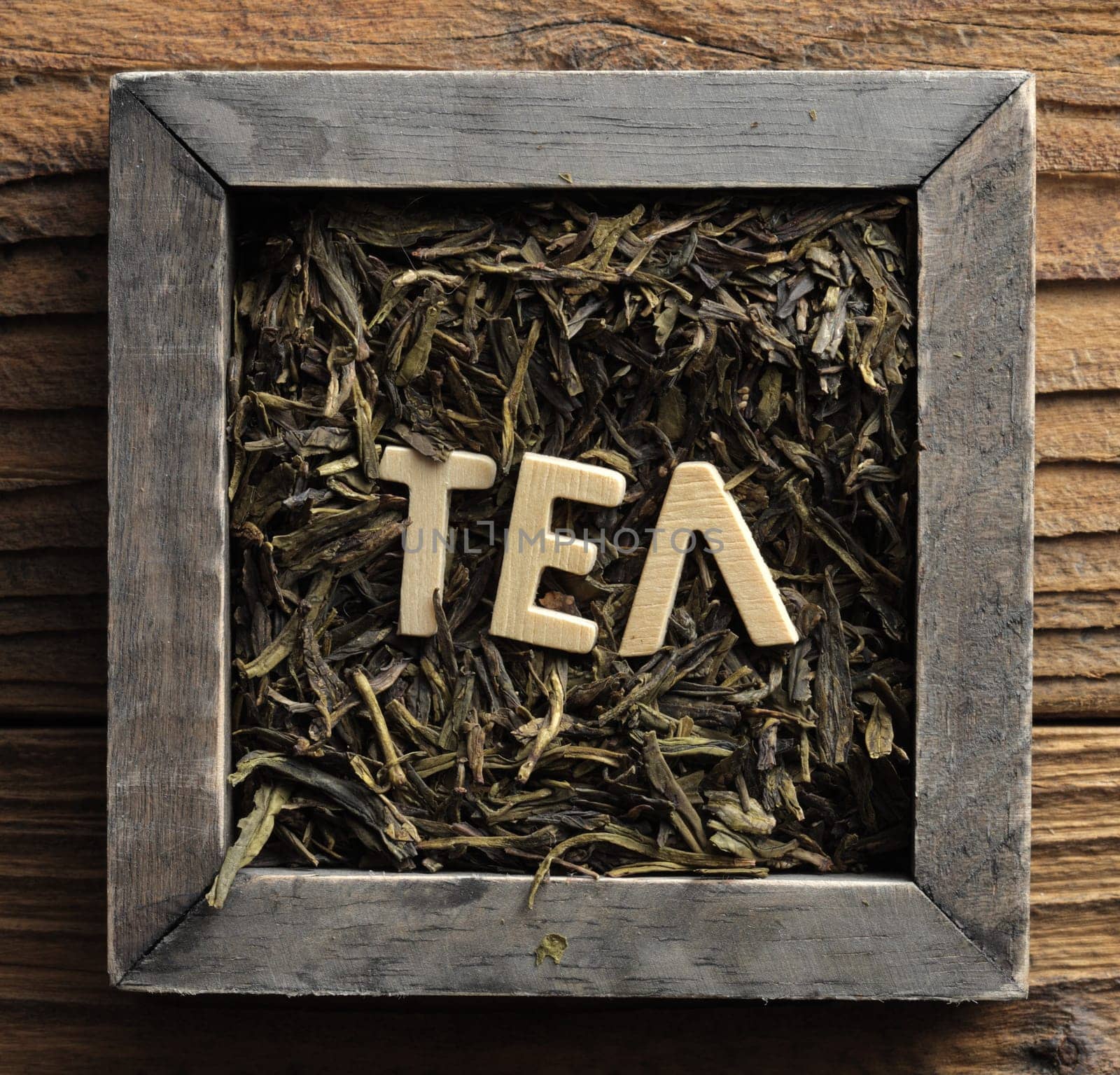Pile of jasmine green tea in a wooden box