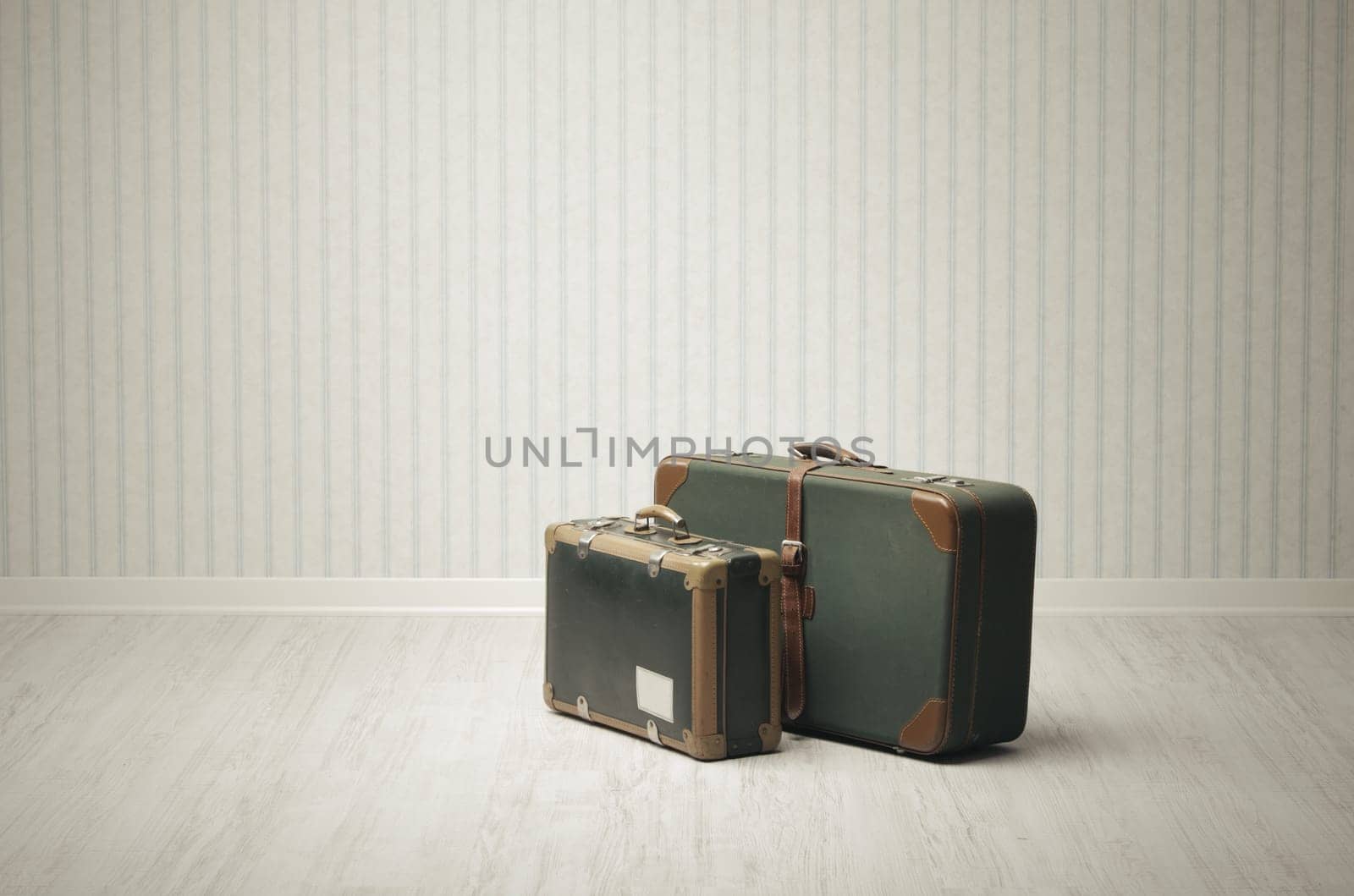 Old-fashioned suitcase alone in a room or station.