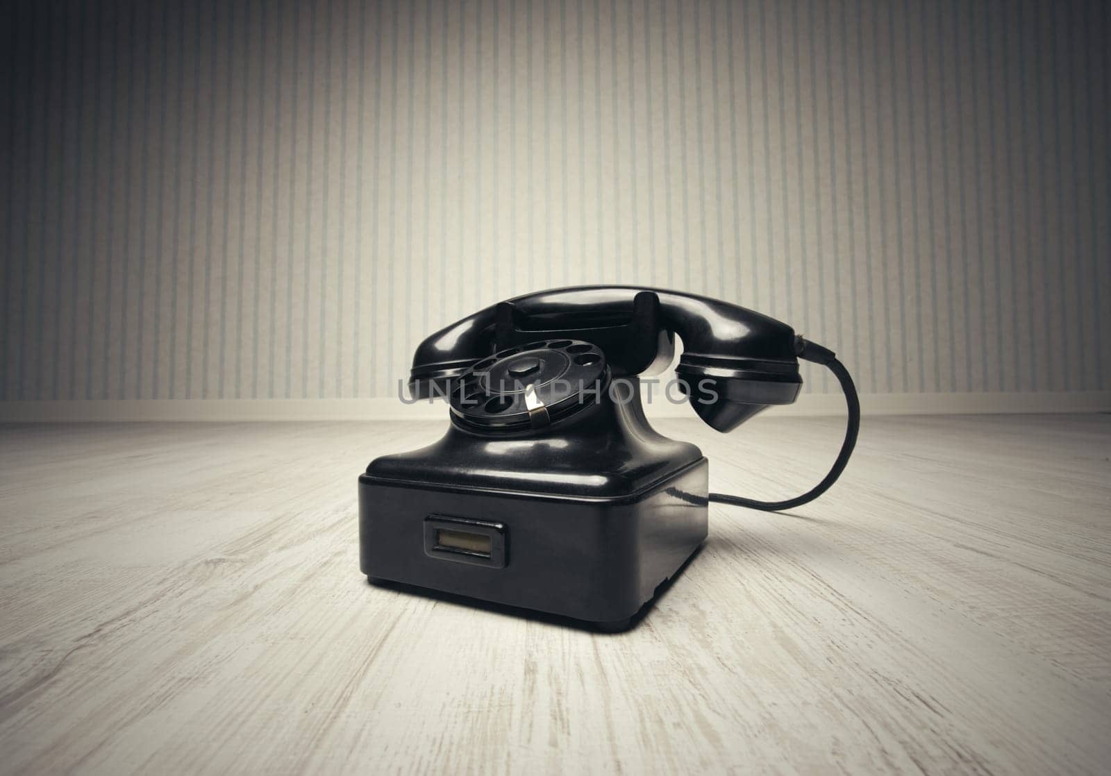 Old-fashioned phone on a wooden floor