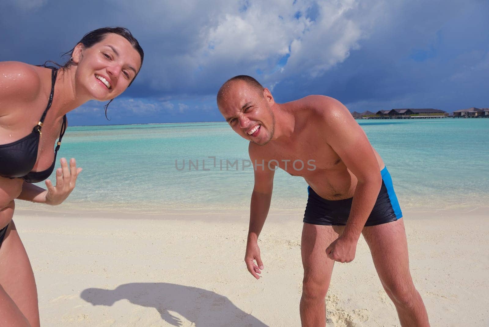 happy young couple have fun and relax at summer vacation on background maldives travel location and beautiful white sand beach
