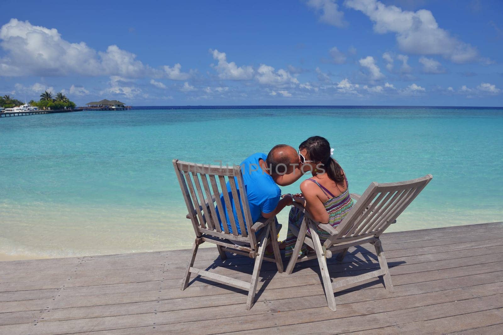 happy young couple have fun and relax at summer vacation on background maldives travel location and beautiful white sand beach