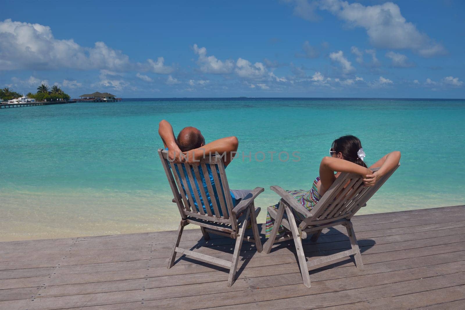 happy young couple have fun and relax at summer vacation on background maldives travel location and beautiful white sand beach