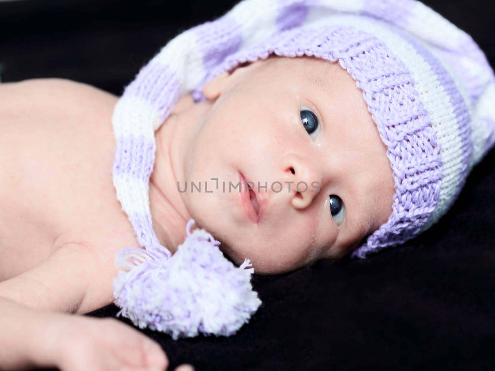 Cute beautiful baby is wearing a funny hat