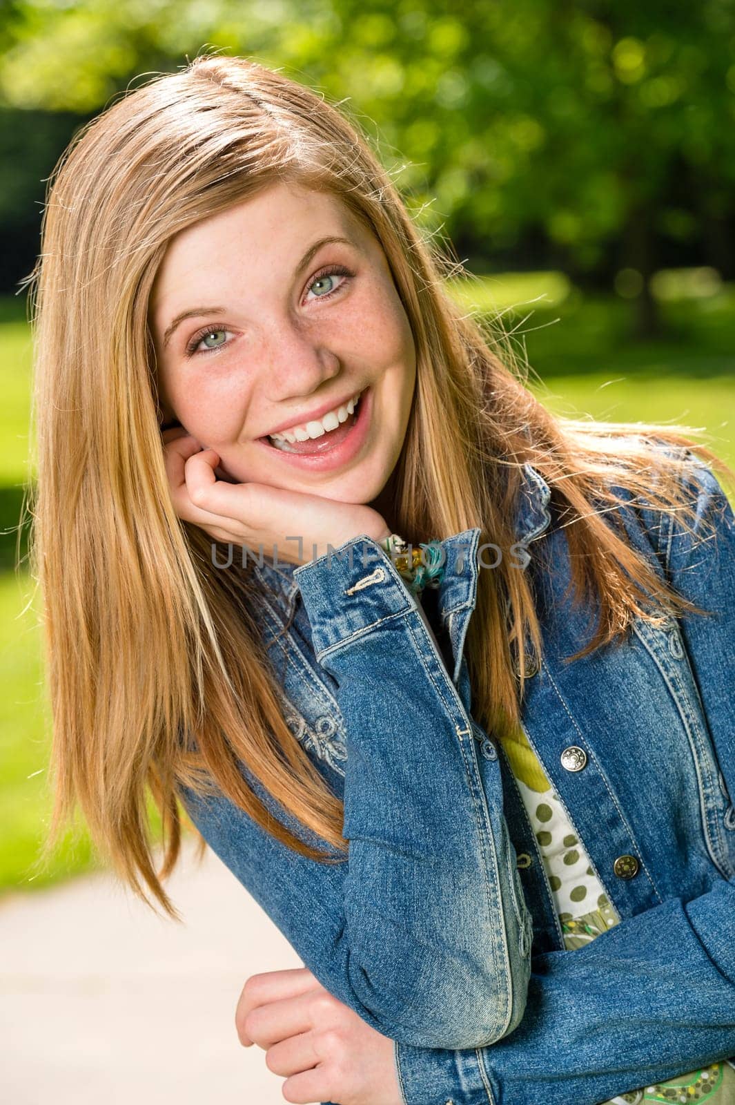 Portrait of smiling teenage girl outside in the sunshine