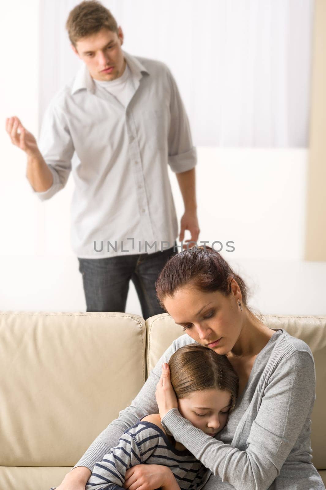 Mother protecting her daughter from angry and violent father