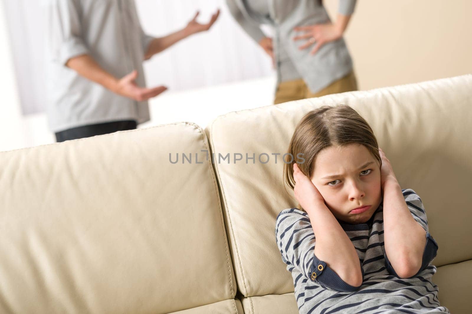Parents fighting in front of their unhappy daughter child