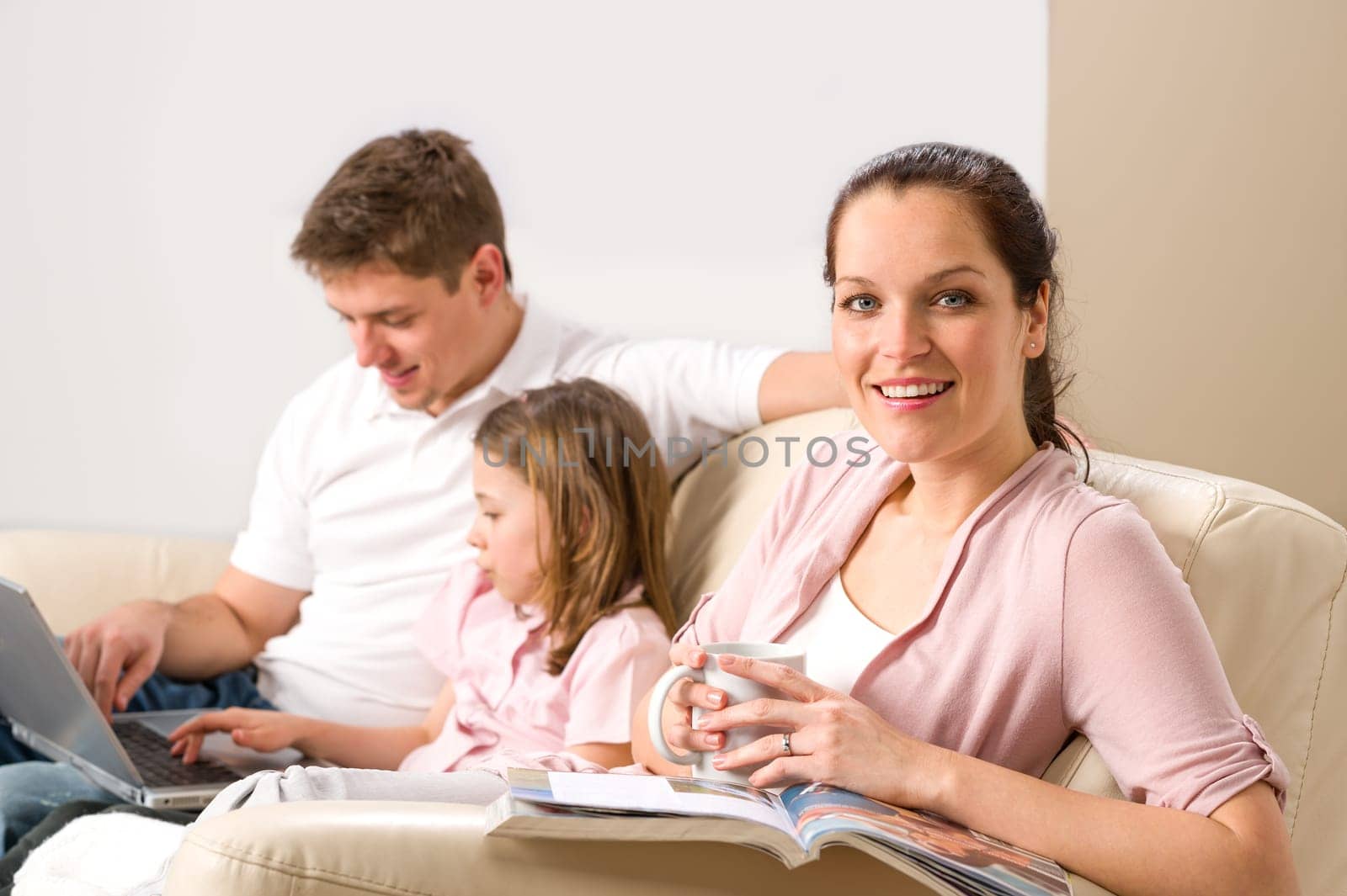 Idyllic family portrait in their home spending leisure time together