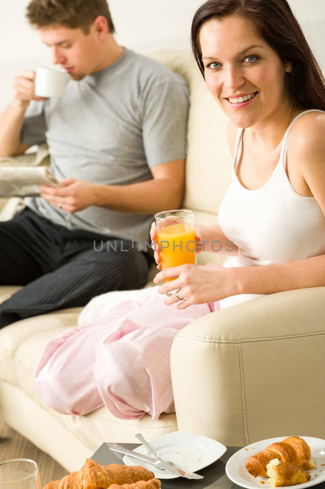 Resting couple having breakfast together in hotel room