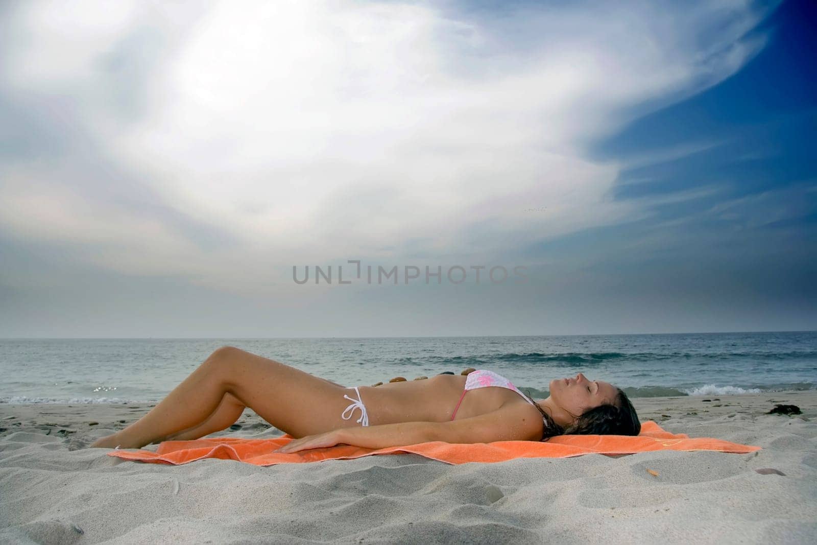 Bright photo of a beautiful model relaxing on a beach