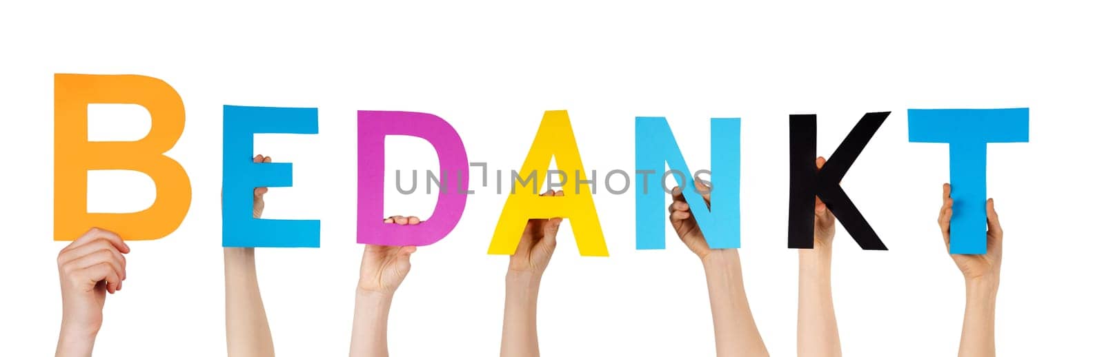 many hands holding the dutch word Bedankt which means thanks