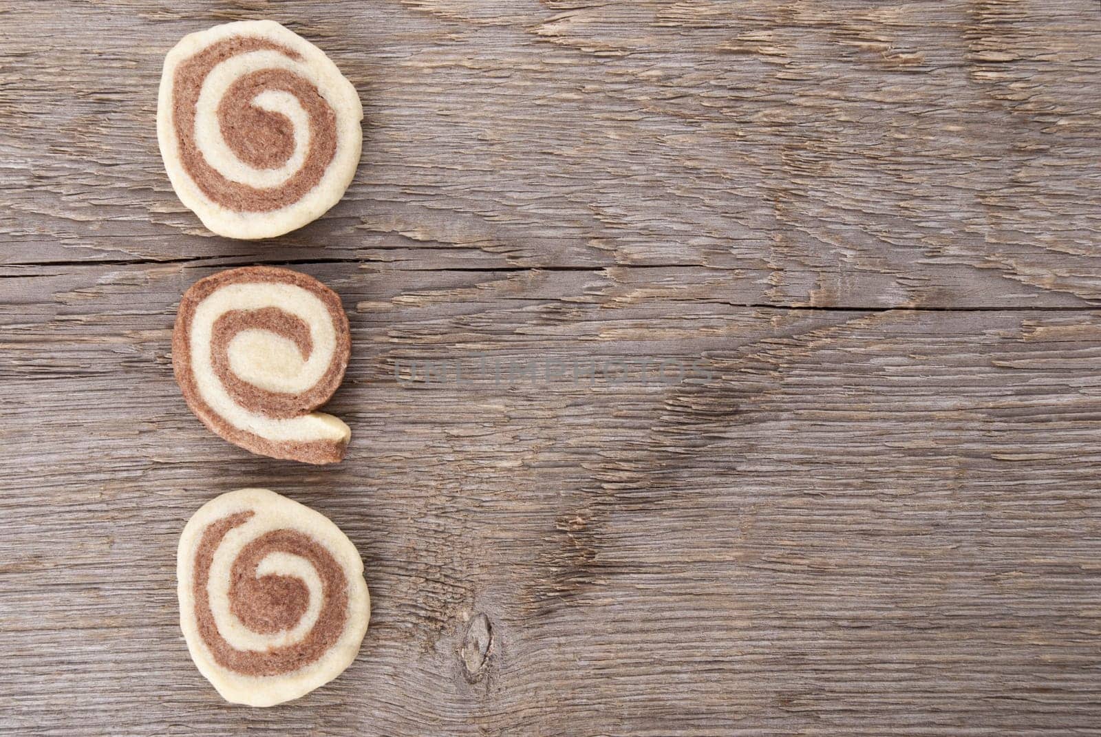three cookies on wood as background with copy space