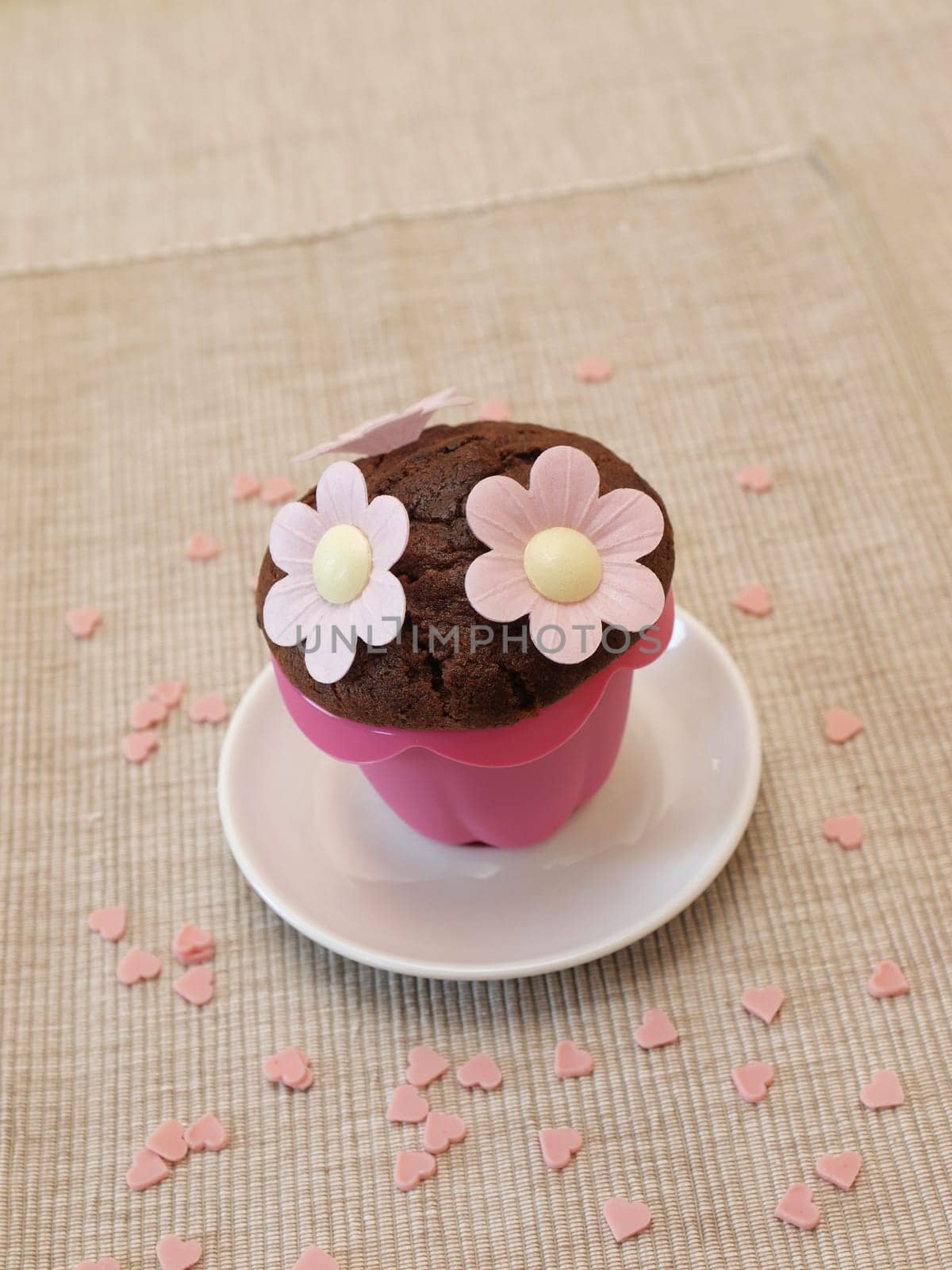 Sweet muffin with flowers and heart shapes