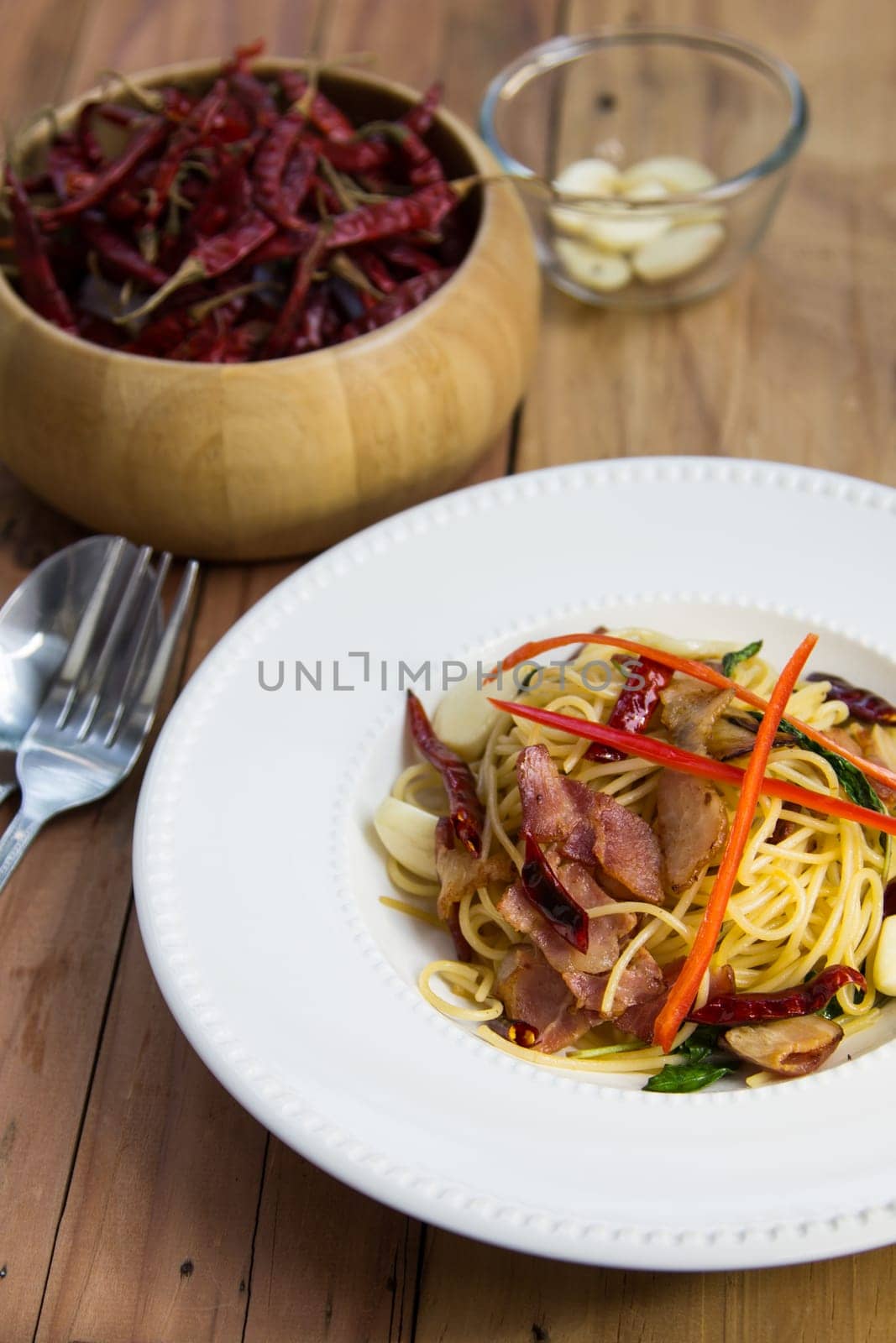 spaghetti with bacon in the pan and herb