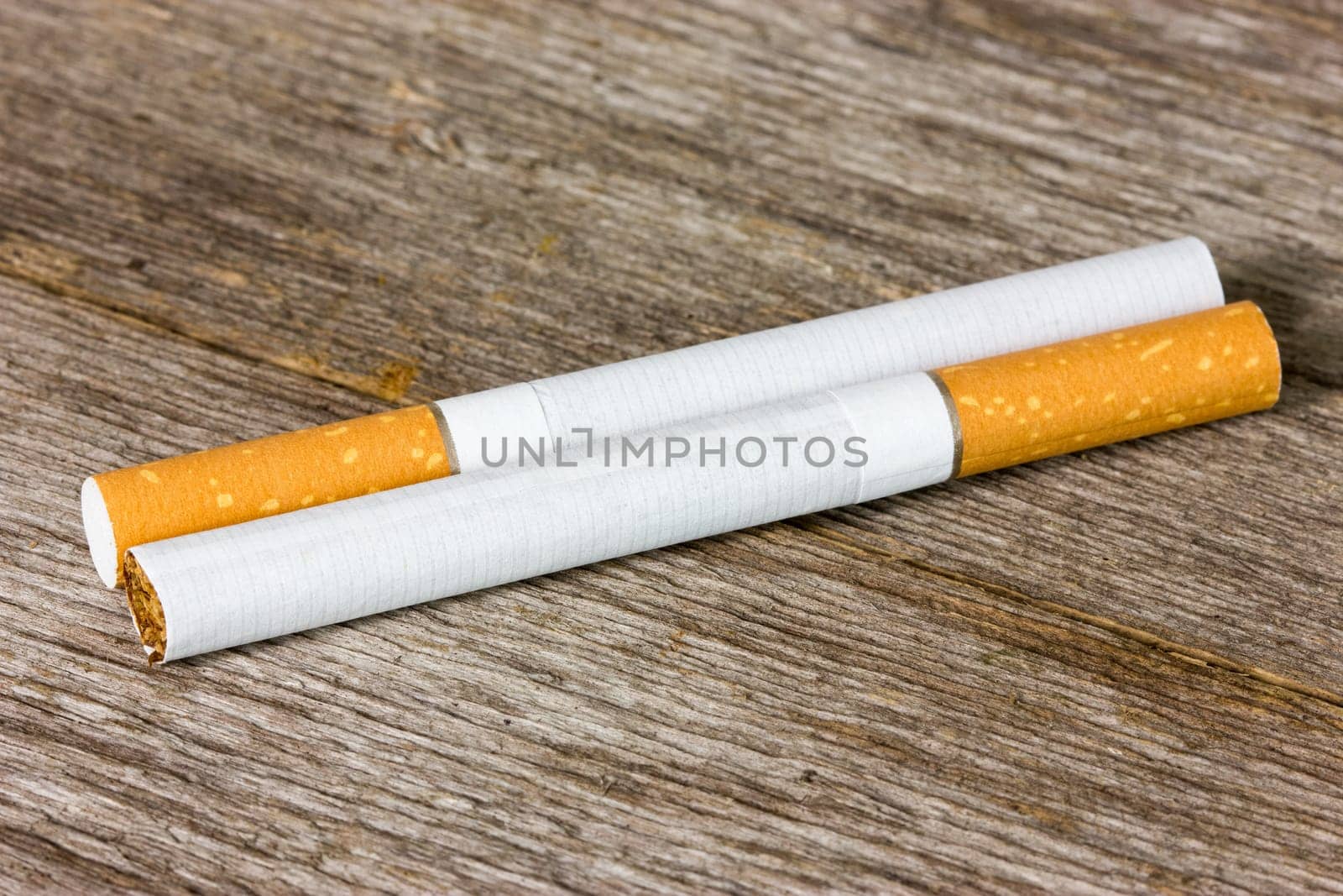 Two cigarettes on the old wooden floor