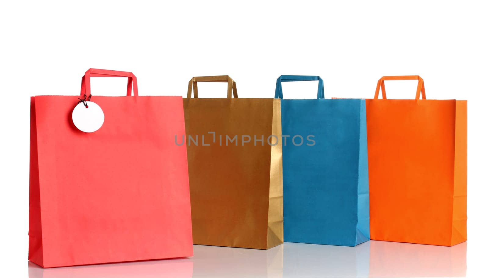 Assorted colored shopping bags over white background