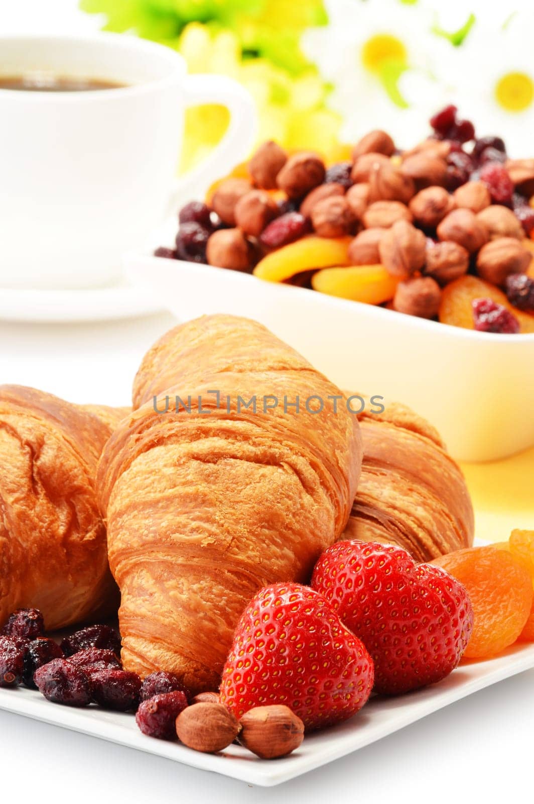 Breakfast with croissants, cup of coffee and fruits