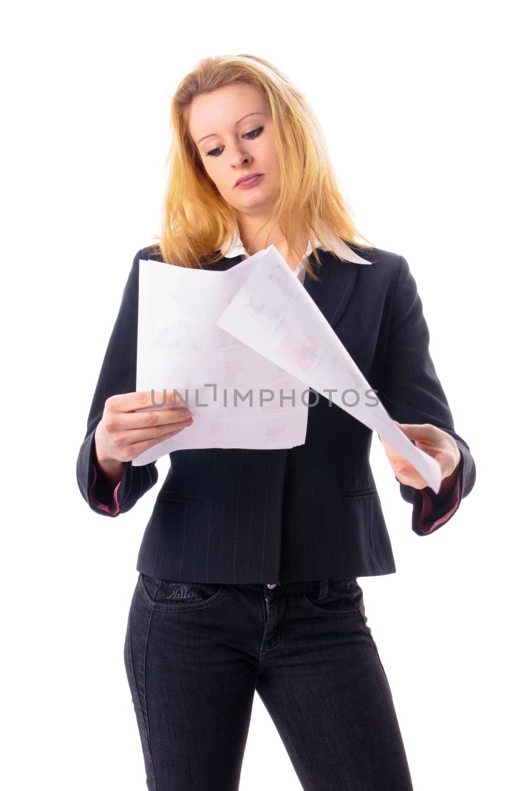 Attractive young woman with long blond hair in a business outfit reads a document,isolated against a white background.
