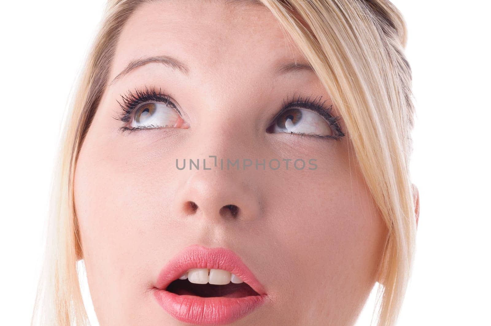 Young attractive woman rolls her eyes,isolated against a white background. Close-up of the face.