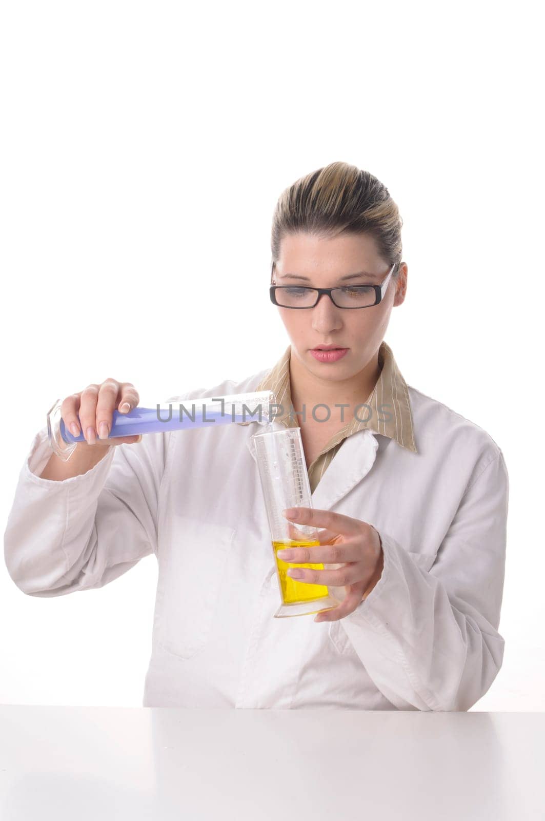 A young pretty woman wears a white coat and handles chemicals and glass bulbs,insulated against a white background.