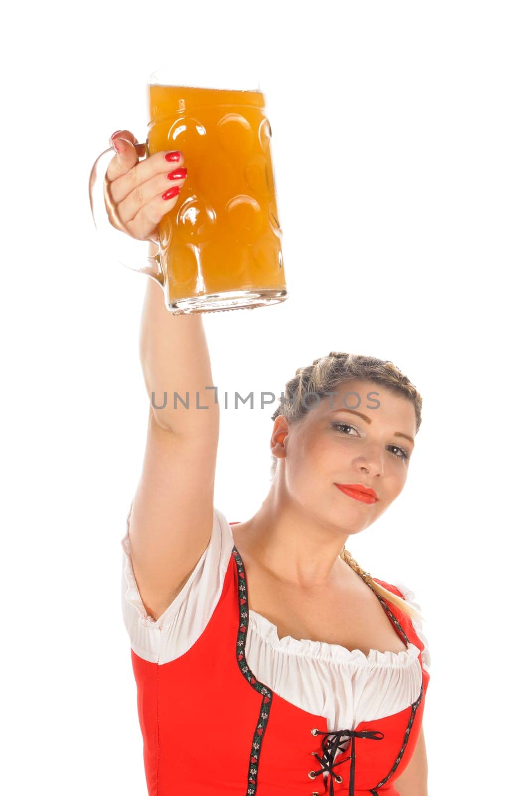 Young attractive woman with blond hair and braids wears a colorful dirdl dress and holds a mug of freshly tapped beer in her hand,exposed against a white background.