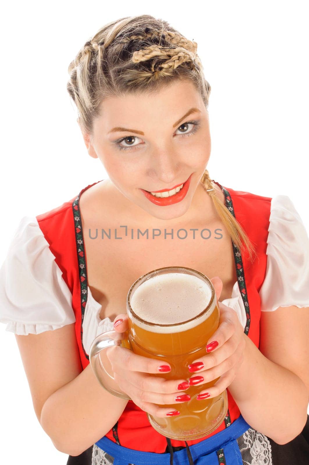 Young attractive woman with blond hair and braids wears a colorful dirdl dress and holds a mug of freshly tapped beer in her hand,exposed against a white background.