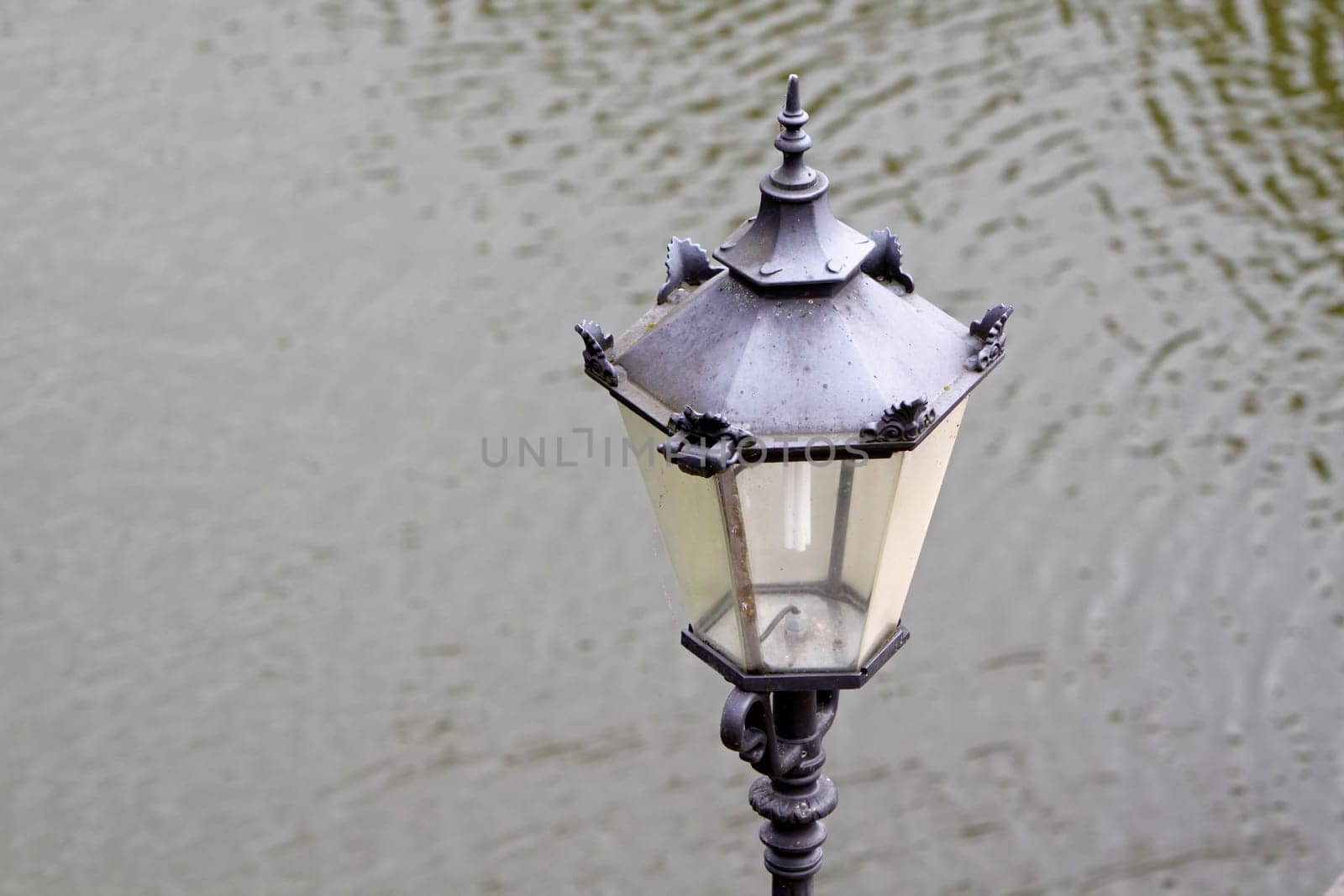 Lantern in front of water surface