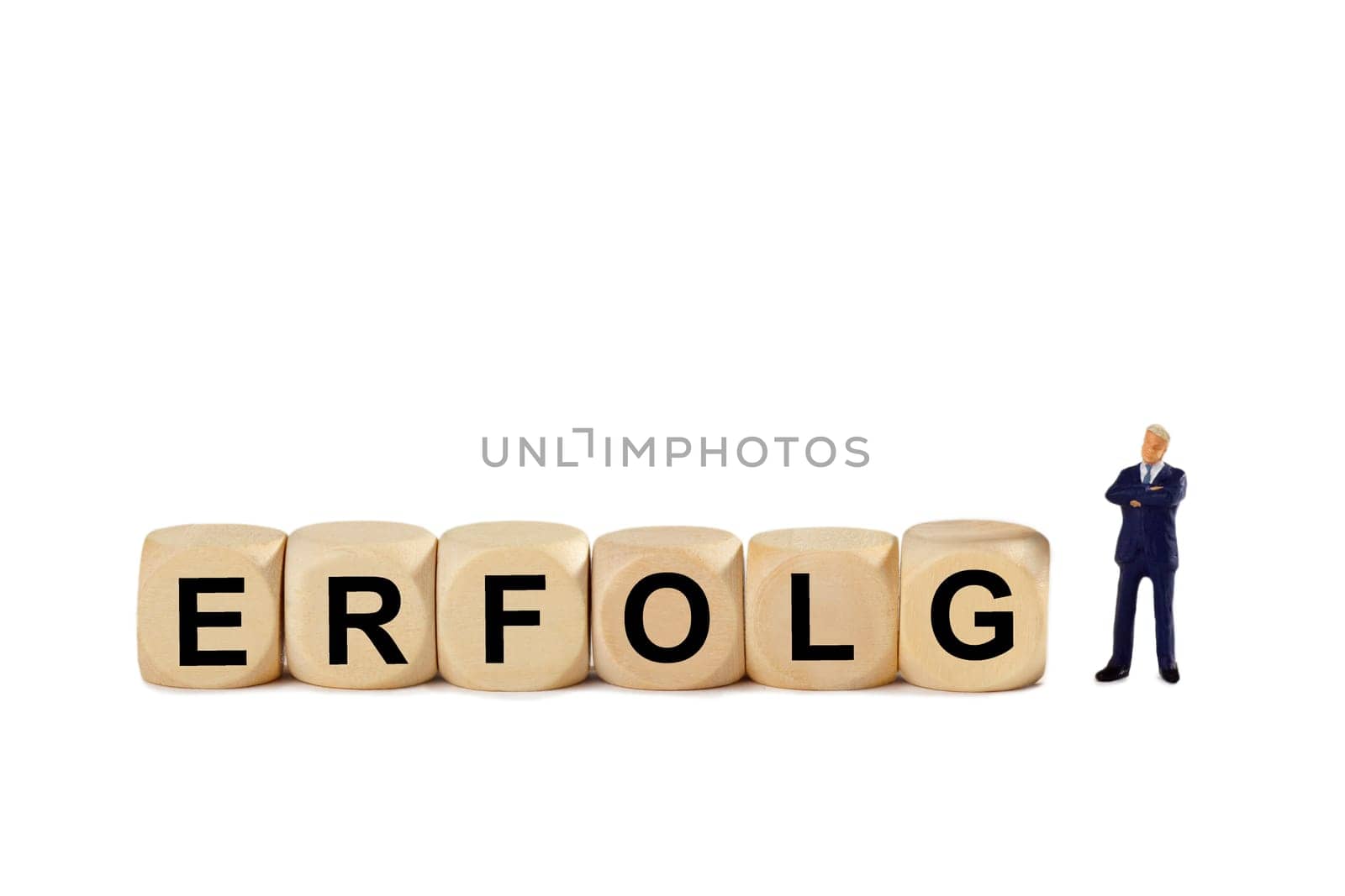 Wooden cube with lettering and miniature figure - cropped on white background